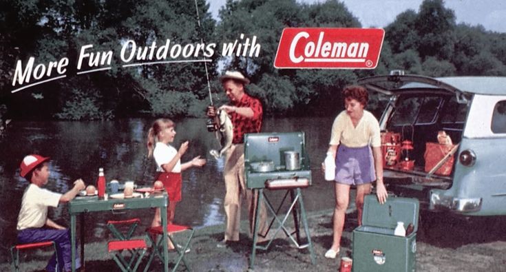 a group of people standing around a table with coolers