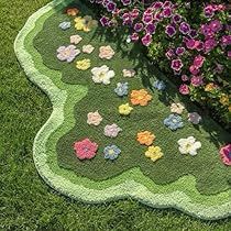 a patchwork rug with flowers on it in the grass