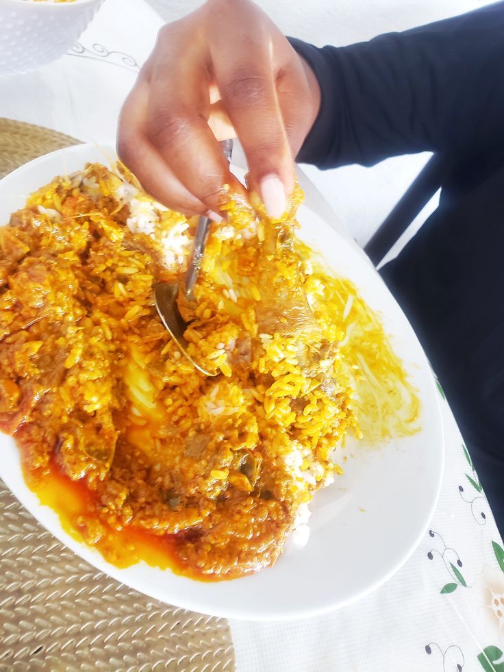 a person is cutting into some food on a plate with a knife and fork in it