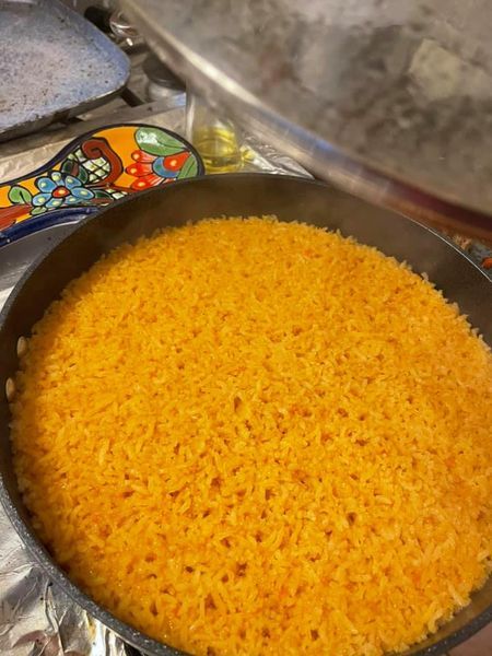 a pan filled with food sitting on top of a stove