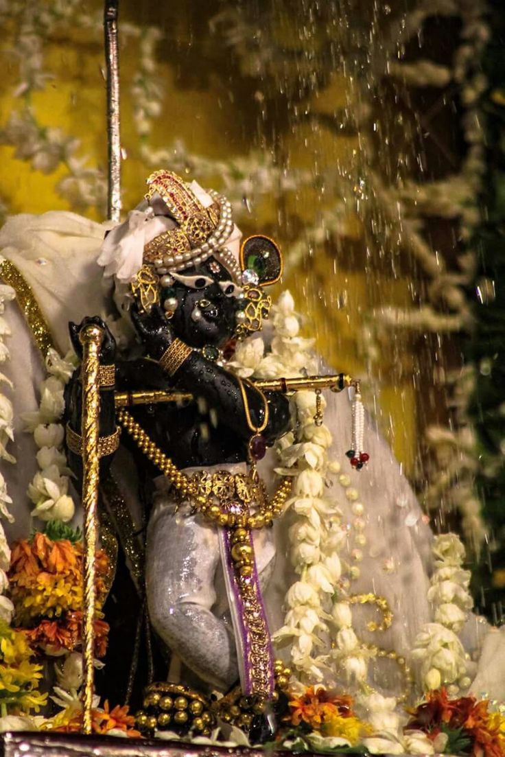 an elaborately decorated statue is displayed in the rain