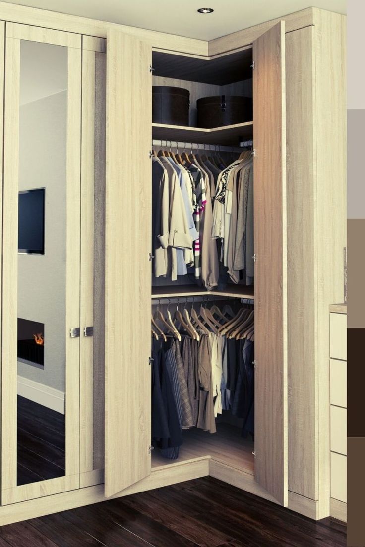 an open closet with clothes hanging in it