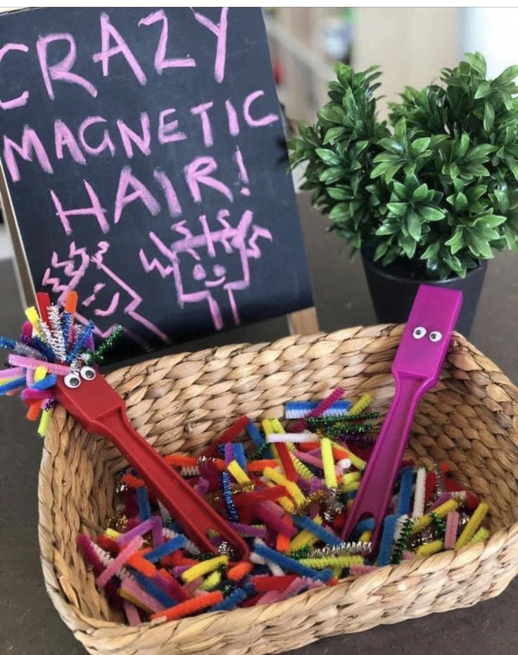 a basket full of crayons and a sign that says crazy magnetic hair sticks