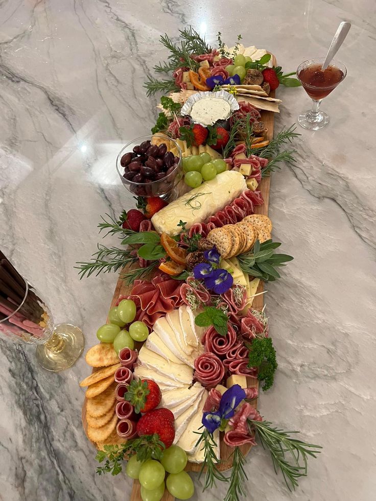 a table topped with lots of different types of cheeses and fruit on top of it