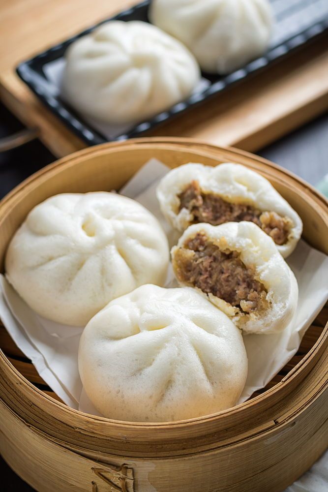 some dumplings are sitting in a basket on a table