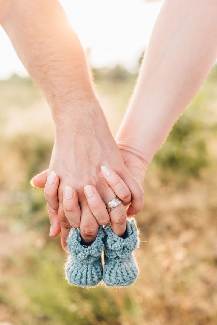 two people holding hands while standing next to each other