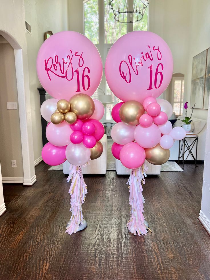 two pink and gold balloons with the number sixteen on them are in front of a doorway