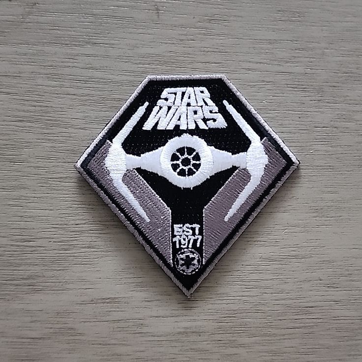 a star wars patch sitting on top of a wooden table