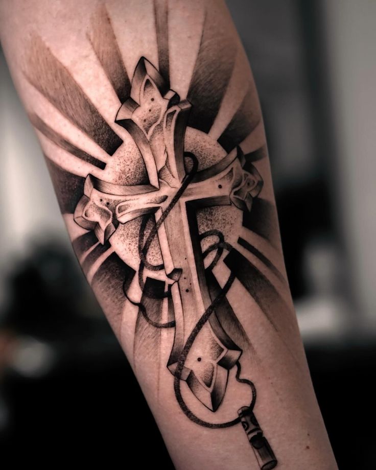 a black and white photo of a cross tattoo