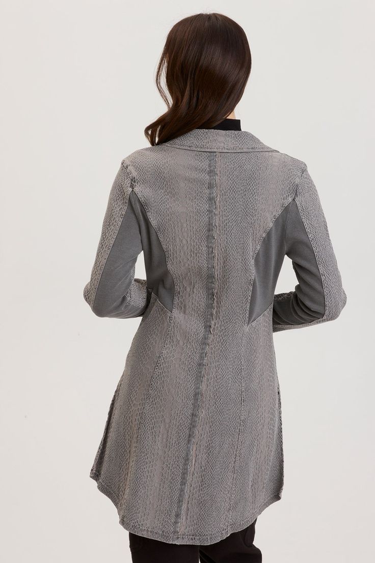 An elongated blazer-style coat with side splits and a one button closure has us jumping for joy. Rhodora features rib panels on the back and undersleeve to give some stretch while pockets and slimming seaming round out this beauty. Camille Jacquard: 60/35/5 Rayon/Nylon/Spandex. 2x1 Rib Contrast: 95/5 Cotton/Spandex. Center Front: ~31". Center Back: ~34.75". Color Description: Mid-tone cool grey . Preshrunk. Machine washable. Imported. MODEL Genevieve is wearing size Small. Height: 5'9" | Bust: 3 Fitted Blazer With Lapel Collar For Layering, Fitted Long Sleeve Blazer For Layering, Fall Layering Outerwear With Thumbholes, Fitted Long Coat Cardigan For Workwear, Fitted Lapel Collar Outerwear For Layering, Fitted Outerwear With Lapel Collar For Layering, Fitted Notch Lapel Outerwear For Layering, Ribbed Paneling, Skirt Crop