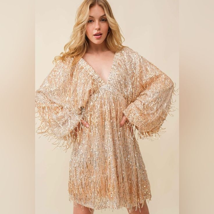 100% Polyester Spring Cocktail Sequin Dress With Shimmer, Metallic Shimmer Dress For Fall, Metallic Long Sleeve Mini Dress For Spring, Spring Metallic Long Sleeve Mini Dress, Chic Metallic Dresses For Festive Occasions, Chic Metallic Festive Dresses, Chic Shimmer Dresses For Fall, Chic Festive Metallic Dresses, Chic Festive V-neck Dresses