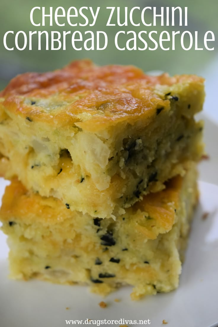 two pieces of cheesy zucchini cornbread casserole on a white plate