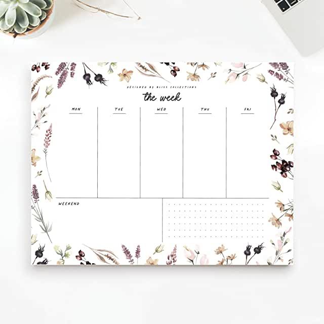 a desk calendar with flowers and plants on it