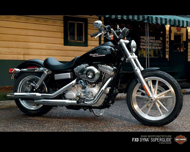 a black motorcycle parked in front of a building