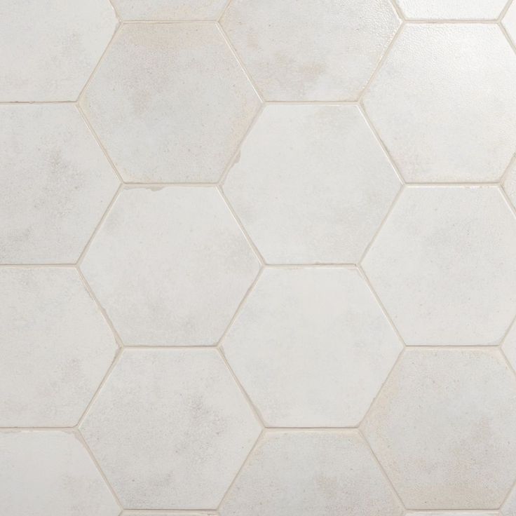 a white tiled floor with hexagonal tiles on it