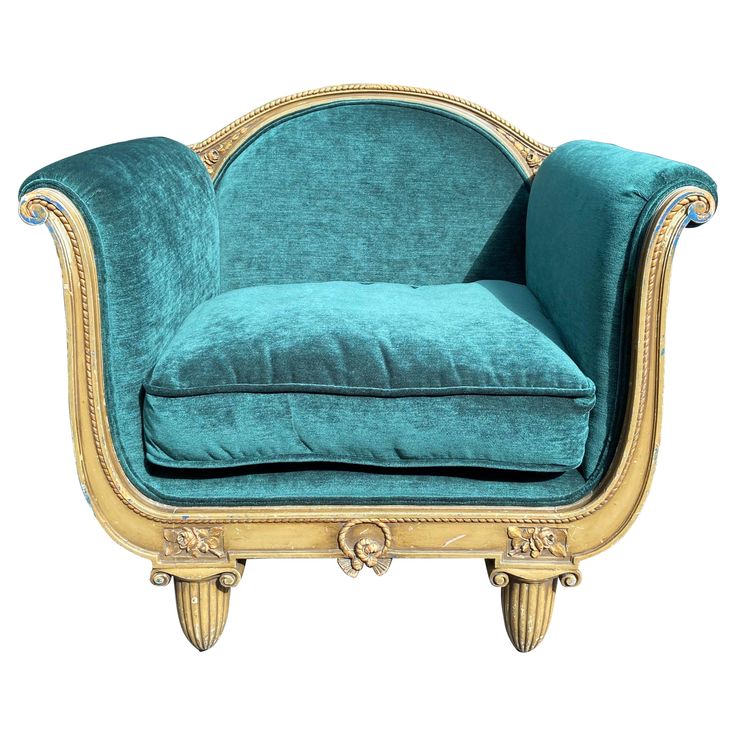 a blue velvet chair with gold trimming