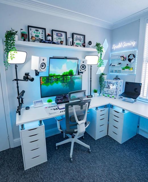 a home office with blue walls and white desks