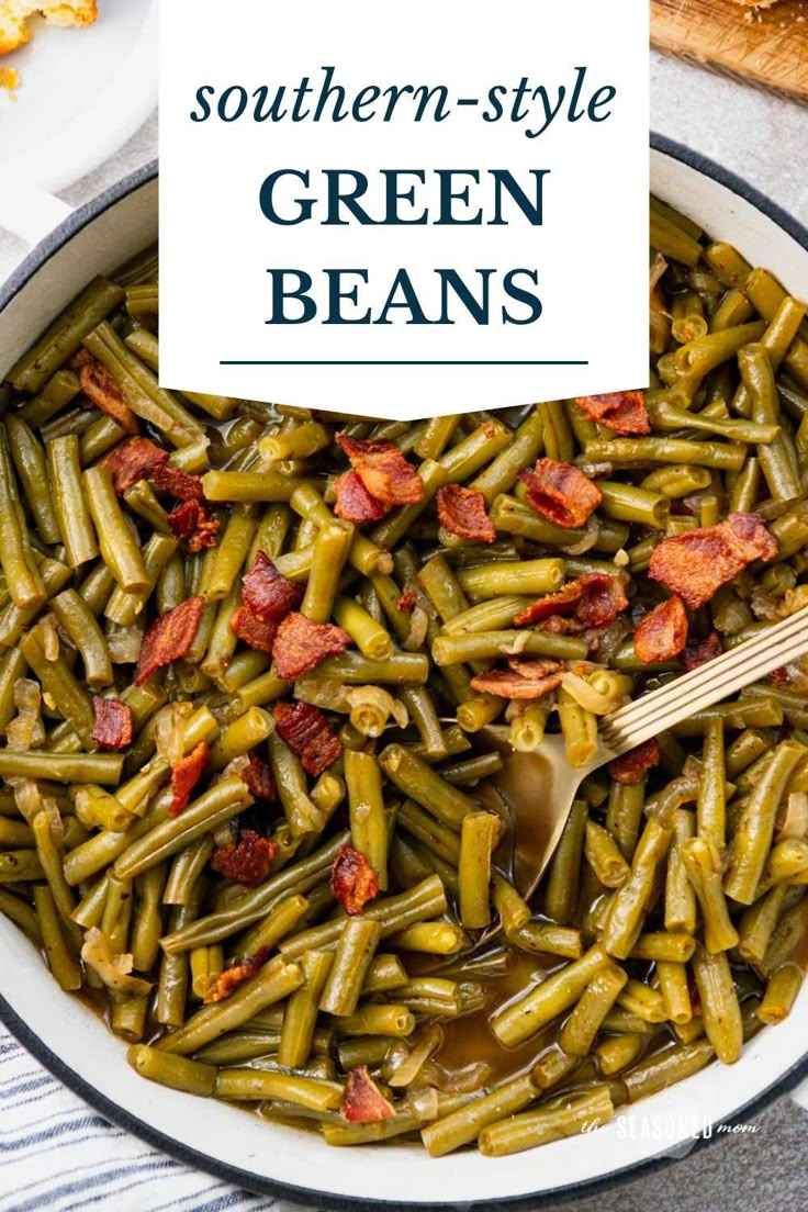 southern - style green beans in a white bowl with a wooden spoon on the side