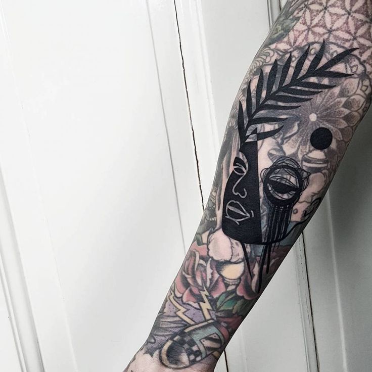 a man's arm with a tattoo on it and a clock in the middle