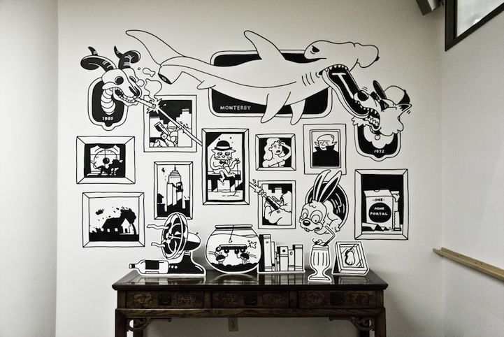 there is a wall with pictures on it in the room that has been decorated with black and white images