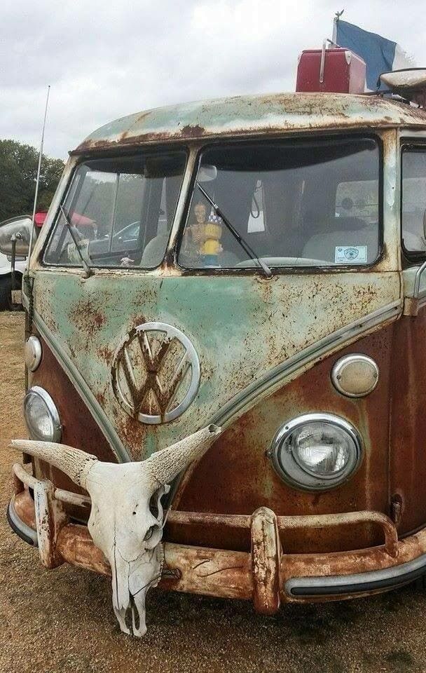 an old vw bus with a steer skull on the front