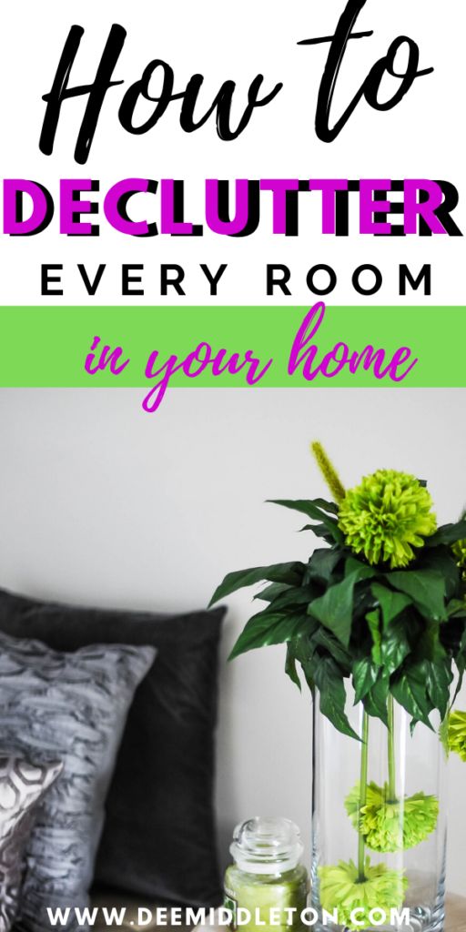 a vase filled with flowers sitting on top of a wooden table next to a bed