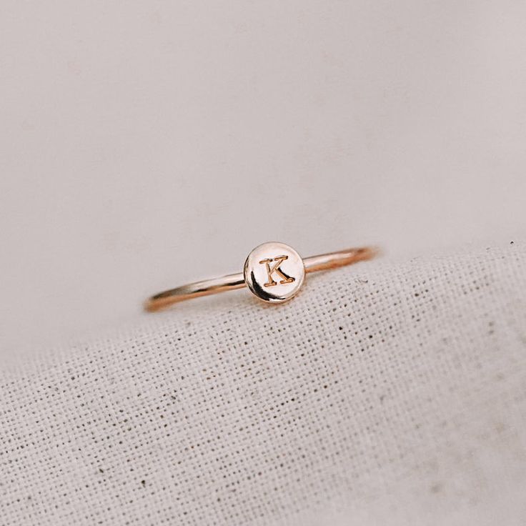 Our dainty initial round disc ring is a meaningful keepsake perfect for everyday wear. Whether it's a adding personal touch or a reminder of a special person/moment, this initial ring also stacks beautifully with our range of other dainty rings. 1 Typewriter Uppercase initial or symbol, hand stamped on our X-TINY disc (approximately 4.5mm in diameter) For symbols - please look at our X-TINY symbols chart in the photos to see what symbols we can stamp Available in sizes 2 US to 15 US Need help with sizing? Look at our size guide or purchase our ring sizer Due to its handmade nature, there may be some colour variances where the solder seam is Each Stamp + Shine piece is made from scratch in our little studio in Melbourne, Australia. The process begins with a clean metal sheet/ wire, which is Dainty 14k Gold Stamped Initial Ring, Dainty Tiny Initial Ring For Gift, Dainty Initials Ring Gift, Minimalist Hand Stamped Silver Initial Ring, Dainty Round Disc Jewelry With Initials, Rectangle Necklace, Crescent Necklace, Oval Necklace, How To Clean Metal