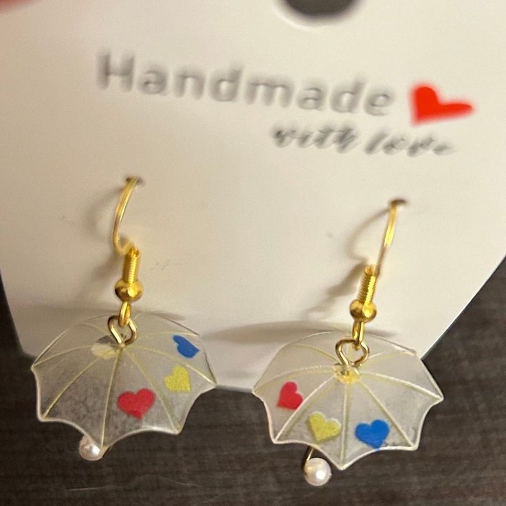 Make a statement with these unique handmade umbrella earrings. The earrings add a bohemian touch to any outfit. The earrings are perfect for any occasion and will make a great addition to your lobe ear area. Choose these beautiful earrings today and add a touch of elegance to your style. Whimsical Earrings For Festivals, Handmade Umbrella, Umbrella Earrings, Rainbow Heart, Jewelry Earrings Studs, Red Heart, Beautiful Earrings, Favorite Jewelry, Etsy Earrings