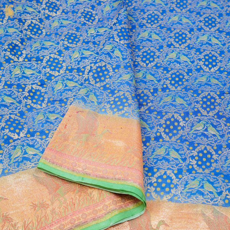 An exclusive Banarasi Handloom saree from Khinkhwab. Add a dash of your favorite color to your ethnic look with this beautiful Banarasi saree from our Birds of Paradise collection. The Saree is made of pure Georgette silk and has the illustrious birds motifs weave. Jaal weave is inherent to Banarasi weaving and this saree is the epitome of the craftsmanship of the renowned weavers of Banaras. Semi-stitched Brocade Pre-draped Saree With Zari Work, Brocade Saree For Puja And Eid, Brocade Pre-draped Saree With Zari Weaving, Brocade Saree For Puja, Diwali Brocade Pre-draped Saree, Brocade Pre-draped Saree For Diwali, Unstitched Brocade Saree With Self Design, Brocade Handloom Saree For Puja, Handloom Brocade Saree For Puja