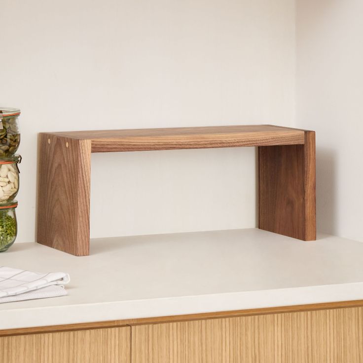 a wooden shelf sitting on top of a white counter