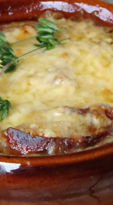 a close up of a bowl of food with meat and gravy on it