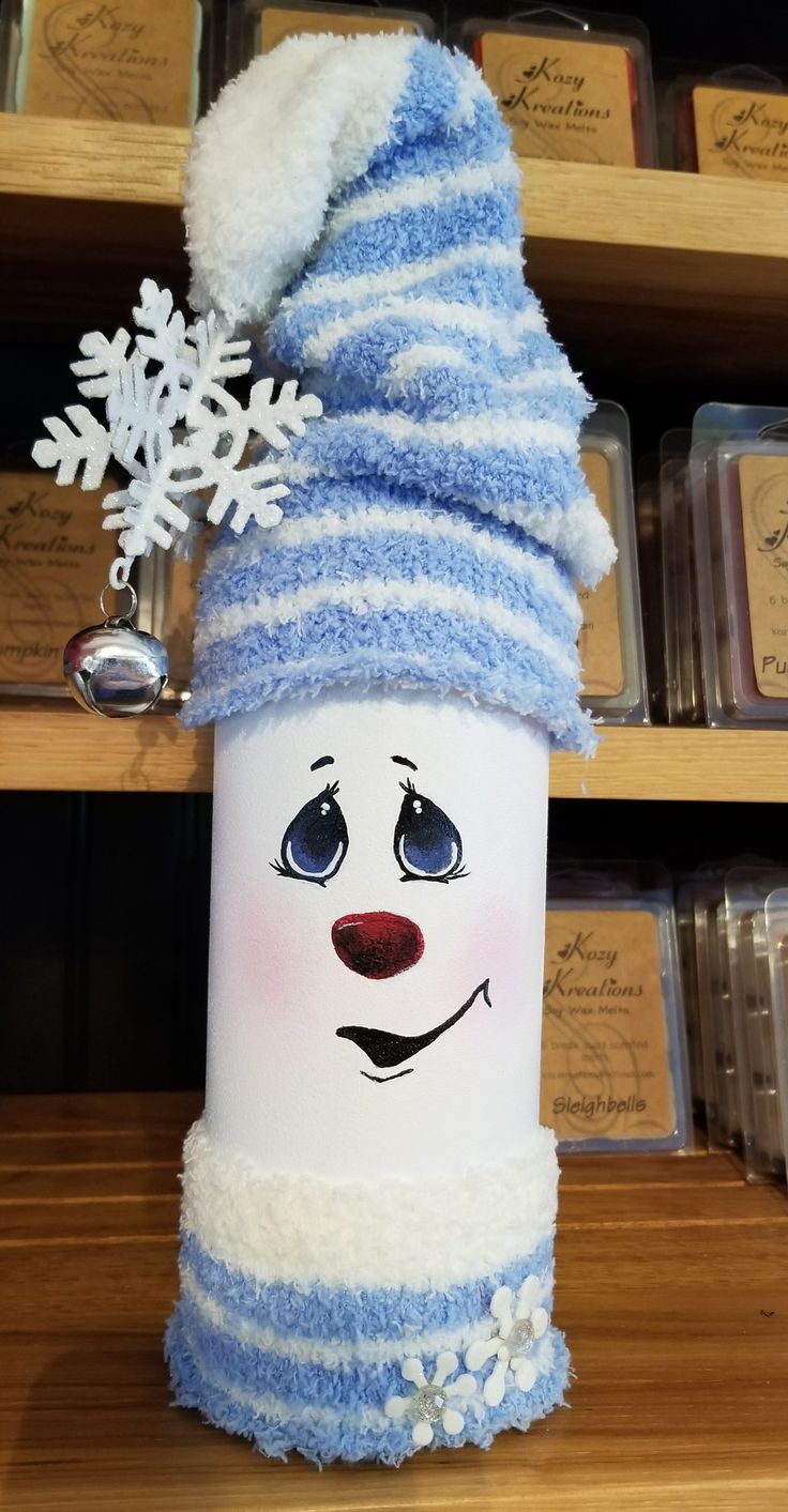 a white and blue frosty cup with a snowman hat on it's head