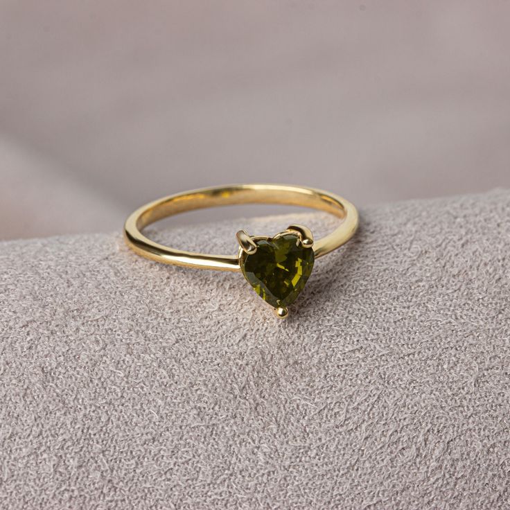 Peridot stone is believed to be auspicious among couples. Peridot is the birthstone for those born in August. We crowned the heart symbol, which is a symbol of love, friendship and many other affections, with precious stones. Now you can see the love at your finger. Other Products Compatible with Our Peridot Heart Ring: https://artdiamonds.etsy.com/listing/1390855208/peridot-heart-necklace14k-solid-gold?utm_source=Copy&utm_medium=ListingManager&utm_campaign=Share&utm_term=so.lmsm&share_time=1692099599065 https://artdiamonds.etsy.com/listing/1545013347/14k-solid-gold-peridot-heart?utm_source=Copy&utm_medium=ListingManager&utm_campaign=Share&utm_term=so.lmsm&share_time=1692107063699 F E A T U R E S * Made to Order. * Gold KT: 14K * Gold Color: Yellow Gold, Rose Gold, White Gold * Peridot Car Peridot Birthstone Ring For Promise, Peridot Birthstone Ring For Promise Occasion, Dainty Peridot Birthstone Ring For Gift, Dainty Peridot Birthstone Ring As Gift, Dainty Peridot Ring For Gift, Dainty Peridot Ring Gift, Heirloom Style Solitaire Birthstone Ring As A Gift, Heirloom Solitaire Birthstone Ring Gift, Heart-shaped Ring For May Birthstone Gift