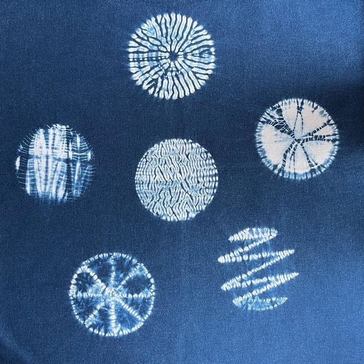 a blue shirt with white designs on it