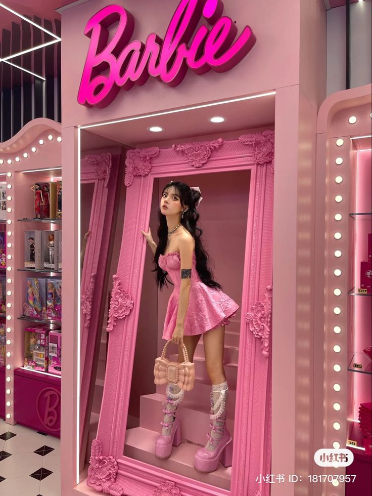 a barbie doll in a pink display case