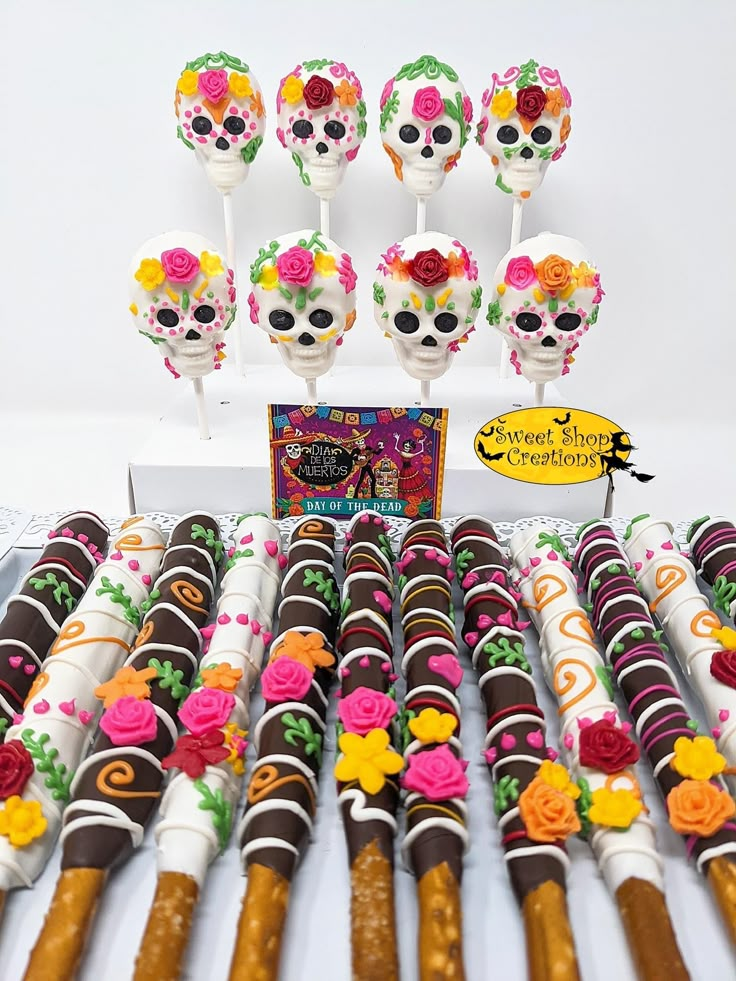 a table topped with lots of candy covered pretzels and lollipops