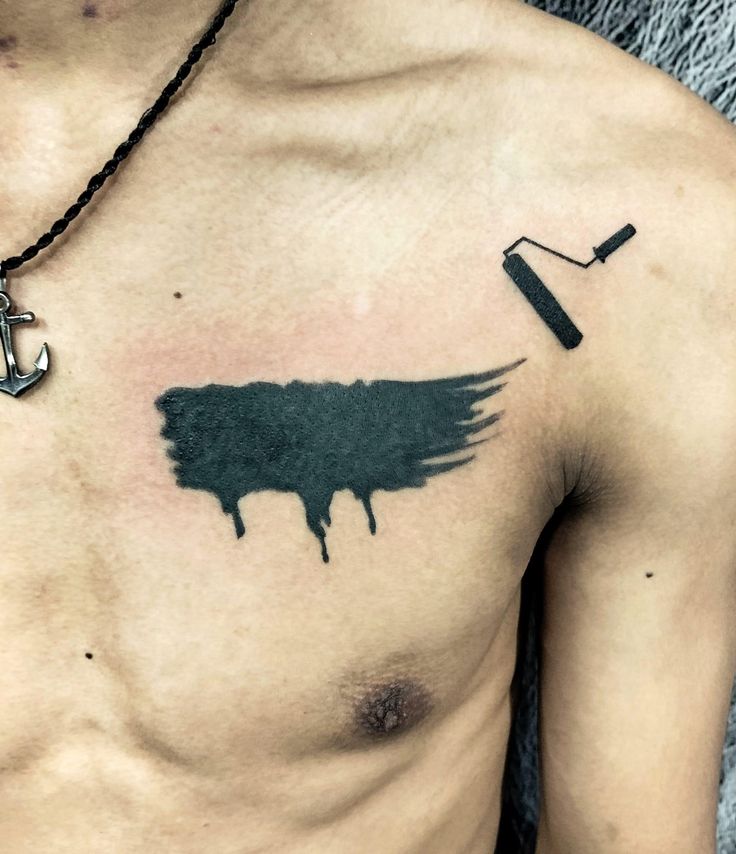 a man's chest is covered in ink with an anchor and hook on it