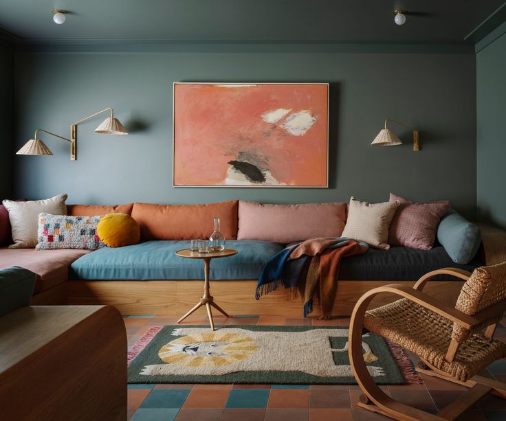 a living room filled with lots of furniture next to a painting hanging on the wall