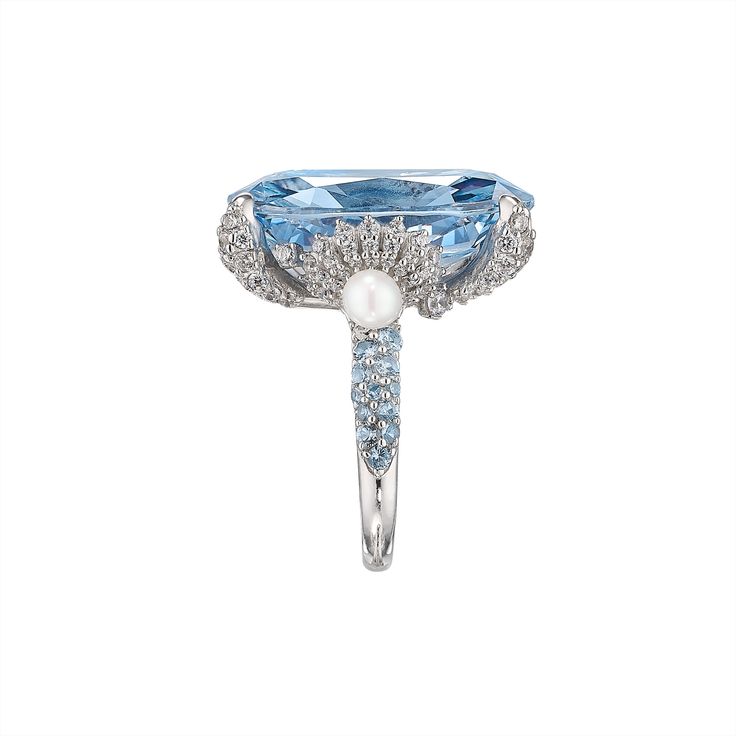 London-based Anabela Chan’s background in architecture and luxury fashion led to the first fine jewelry line to champion laboratory-grown gemstones. Today, its artisanal craftsmanship and sustainable innovations have found a place in the collections of royals, Rihanna, Taylor Swift, and sophisticated women worldwide. The Baby Blue Mermaid Ring features a breathtaking 18 carat simulated aquamarine at its center. Other stones feature pavé simulated white diamonds and cultured freshwater pearls. Pr Luxury Sapphire Diamond Ring With 17 Jewels, Formal Sapphire Crystal Ring With Center Stone, Elegant Sapphire Crystal Diamond Ring, Elegant Sapphire Crystal Ring With Diamond, Luxury Crystal Ring With Gemstone Accents For Wedding, Elegant Sapphire Crystal Ring For Formal Occasions, Luxury Topaz Ring With Diamond Accents, Luxury Open Ring With Sapphire, Luxury Sapphire Gemstone Cluster Ring