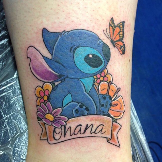 a small tattoo on the leg of a woman with an image of stitching stitch