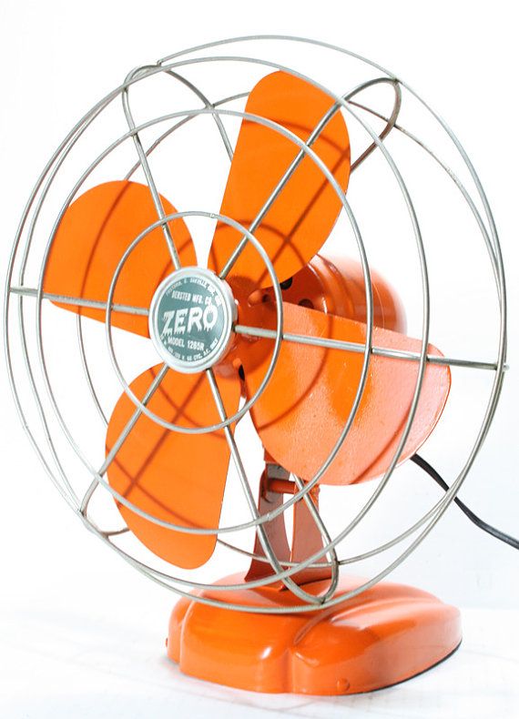 an orange table fan on a white background