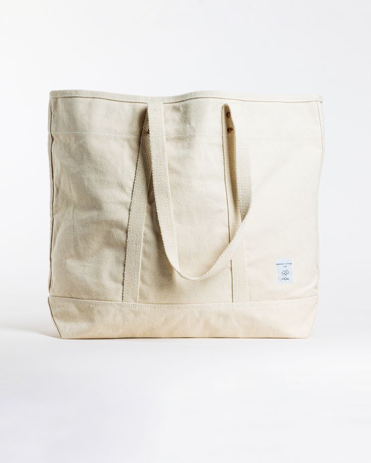 This Large East West Tote from Immodest Cotton is the perfect bag for weekend getaways and trips to the farmers market. With double stitched seams and removable leather handles, this cotton canvas shoulder bag converts to a handheld tote with ease. Not to mention - we love this neutral shade of canvas. Details + Design: Converts from handheld to shoulder with detachable leather handles. Remove the leather handles to wash. One interior pocket. Material: Cotton canvas. Undyed leather handles. Hand Cotton Shoulder Weekender Bag For Travel, Rectangular Cotton Weekender Bag For Travel, Casual Cotton Travel Bag With Leather Handles, Travel Canvas Bag With Cotton And Canvas Lining, Travel Cotton Canvas Bag With Canvas Lining, Everyday Weekender Bag With Double Reinforced Handles, Cotton Tote Bag With Reinforced Handles, Cotton Tote Shoulder Bag With Canvas Lining, Cotton Tote Shoulder Bag With Reinforced Handles