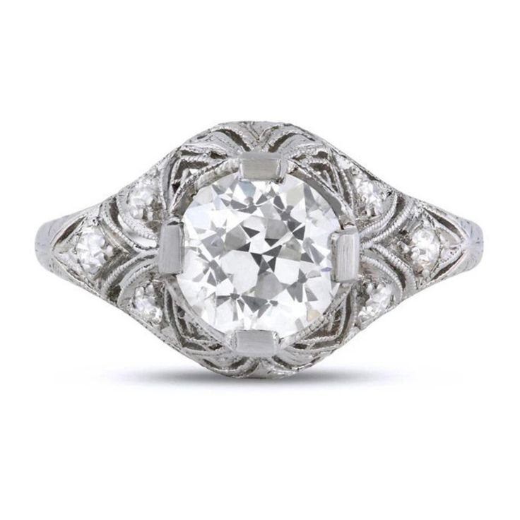 an old - fashioned diamond ring with filigrees on the shoulders and sides