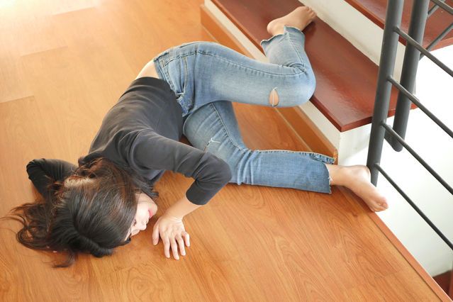 a woman is laying on the floor with her head down and hands behind her back