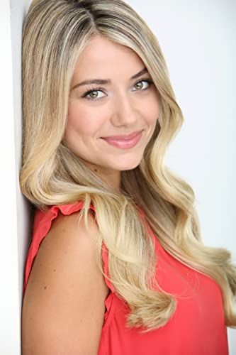 a woman with long blonde hair posing for a photo