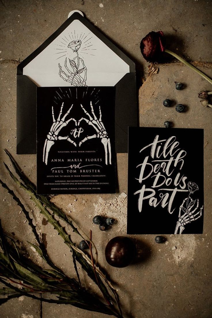 two black and white wedding stationery cards with hand drawn lettering on the front, one is