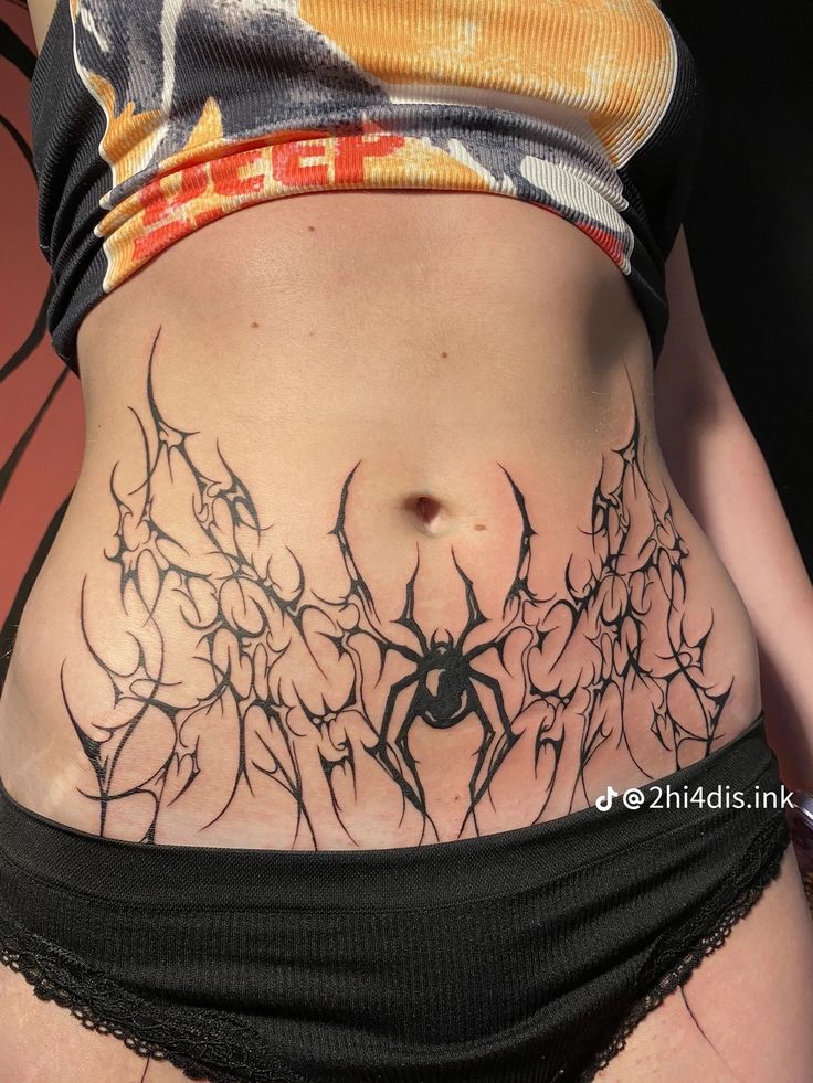 a woman's stomach with spider web tattoo on the top and bottom part of her body