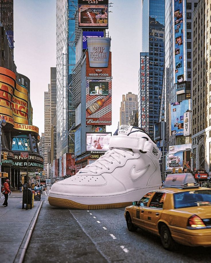 a pair of white sneakers on the side of a city street