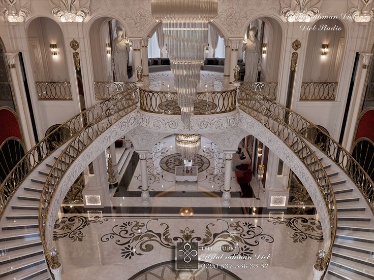 the inside of a large building with stairs and chandeliers on each side of it