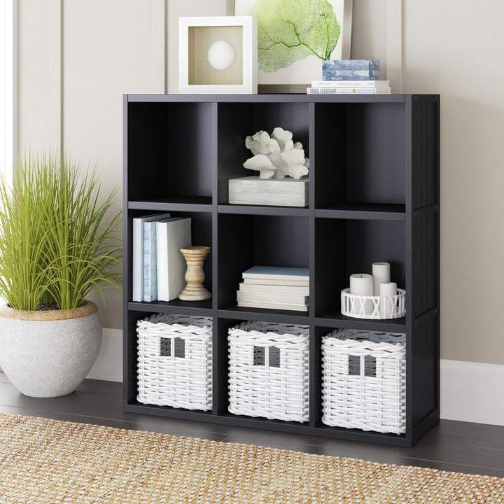 a shelf with baskets and books on it